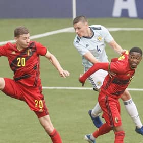 Belgium's Ignace Van der Brempt, Scotland's Lewis Mayo and Belgium's Michel Ange Balikwisha fight for the ball  (Photo by BRUNO FAHY/BELGA MAG/AFP via Getty Images)