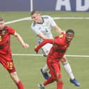 Belgium's Ignace Van der Brempt, Scotland's Lewis Mayo and Belgium's Michel Ange Balikwisha fight for the ball  (Photo by BRUNO FAHY/BELGA MAG/AFP via Getty Images)