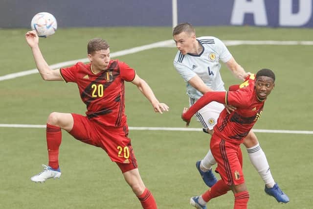 Belgium's Ignace Van der Brempt, Scotland's Lewis Mayo and Belgium's Michel Ange Balikwisha fight for the ball  (Photo by BRUNO FAHY/BELGA MAG/AFP via Getty Images)