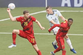 Belgium's Ignace Van der Brempt, Scotland's Lewis Mayo and Belgium's Michel Ange Balikwisha fight for the ball  (Photo by BRUNO FAHY/BELGA MAG/AFP via Getty Images)