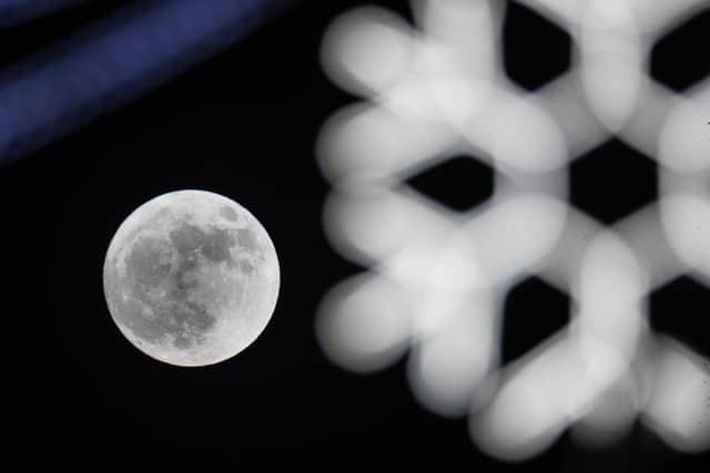 A 'Wolf Moon' behind festive seasonal lights on display in the High Street in Wells in 2018 (Photo: Matt Cardy/Getty Images)