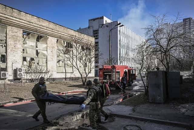 Military emergency service members remove the body of a dead Ukrainian serviceman in the area of a research institute, part of Ukraine's National Academy of Science, after a strike, in northwestern Kyiv. Picture: Aris Messinis/AFP via Getty Images