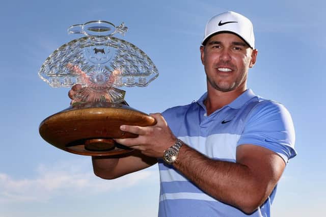 Brooks Koepka poses with the trophy after winning the the Waste Management Phoenix Open at TPC Scottsdale. Picture: Christian Petersen/Getty Images.