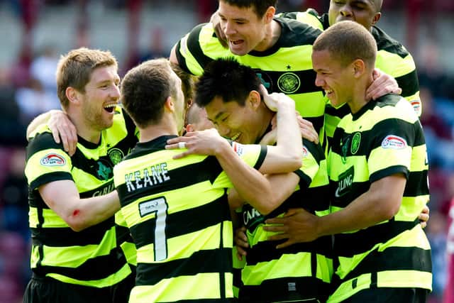 Zheng Zhi (centre) is mobbed by his team mates after scoring his only goal for Celtic in an end of season match against Hearts at Tynecastle.