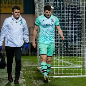 Hibs' Kevin Nisbet went off with a hamstring injury during the 1-1 draw at Ross County.