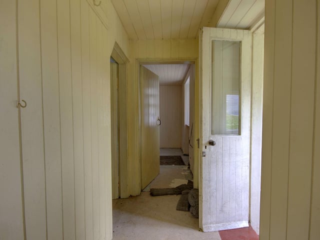 The stone-built cottage has two bedrooms on the upper floor with the walls finished in traditional wood panelling. Two open fires heat the ground floor.