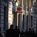 Pedestrians walk past a Post office sign. Picture: Justin Tallis/AFP via Getty Images