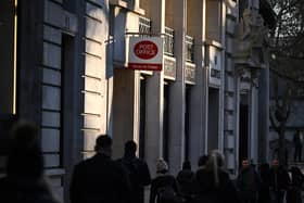 Pedestrians walk past a Post office sign. Picture: Justin Tallis/AFP via Getty Images