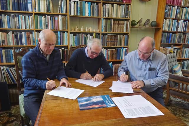 The three community chairs involved in the St Kilda Trail sign the memorandum of understanding