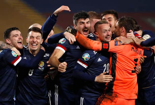 David Marshall is swamped by his Scotland team-mates after saving the winning penalty in the Euro 2020 play-off final shoot-out. Picture: Getty