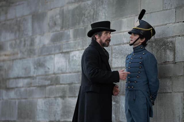 Christian Bale as Augustus Landor and Harry Melling as Edgar Allen Poe in The Pale Blue Eye PIC: Scott Garfield/Netflix © 2022