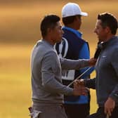 Collin Morikawa, left, shakes hands with Rory McIlroy on the 18th green after the second round of the 150th Open. Picture: Harry How/Getty Images.