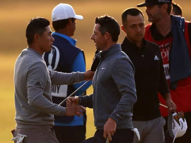 Collin Morikawa, left, shakes hands with Rory McIlroy on the 18th green after the second round of the 150th Open. Picture: Harry How/Getty Images.