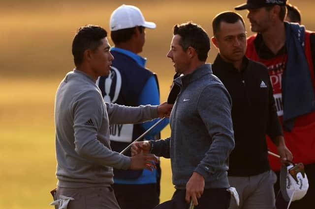 Collin Morikawa, left, shakes hands with Rory McIlroy on the 18th green after the second round of the 150th Open. Picture: Harry How/Getty Images.