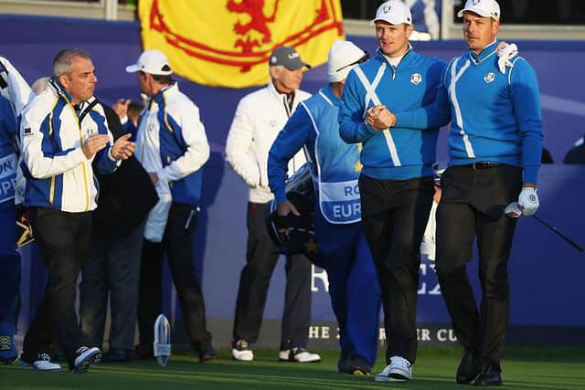 Paul McGinley encourages Justin Rose and Henrik Stenson as they leave the first tee during the 2014 Ryder Cup at Gleneagles. Picture: Ross Kinnaird/Getty Images.