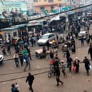Palestinians, including many displaced from other areas in the Gaza Strip, walk through a main square in Rafah near the border with Egypt.