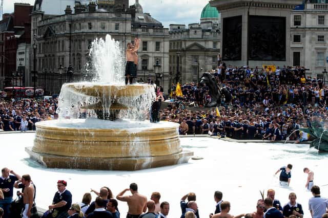 Scotland fans take over London as the Tartan Army cool off in the fountain at Trafalgar Square in 2013.