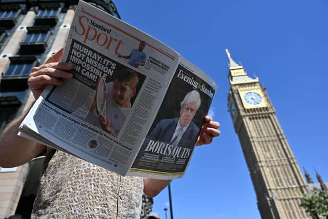 A member of the public holds a copy of the Evening Standard newspaper, leading with story that Britain's Prime Minister Boris Johnson has resigned as leader of the Conservative Party, by the Houses of Parliament in central London on July 7, 2022. - Boris Johnson resigned on Thursday as leader of Britain's Conservative party, paving the way for the selection of a new prime minister after dozens of ministers quit his government over 48 hours of frenzied political drama. (Photo by JUSTIN TALLIS / AFP) (Photo by JUSTIN TALLIS/AFP via Getty Images)