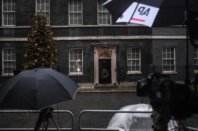 TV cameras are stationed outside 10 Downing Street on Sunday.
