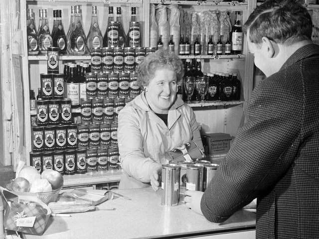 A customer stocks up for Hogmanay at Edinburgh's HJ Hildersley licensed grocers.