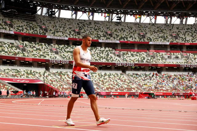 An emotional Adam Gemili walks to the finish during his 200m heat