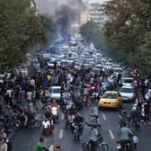 Demonstrators take to the streets of the capital Tehran in September last year, following the death of Mahsa Amini in police custody (Picture: AFP via Getty Images)