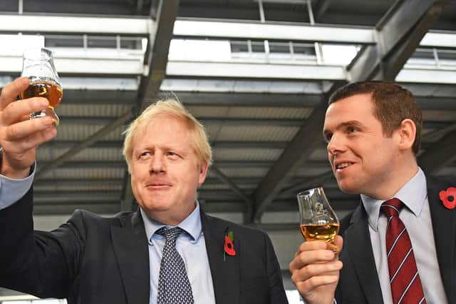 Boris Johnson with Scottish Conservative Party leader Douglas Ross who resigned from the Government over Dominic Cummings' alleged breach of lockdown rules (Picture: Stefan Rousseau/PA Wire)