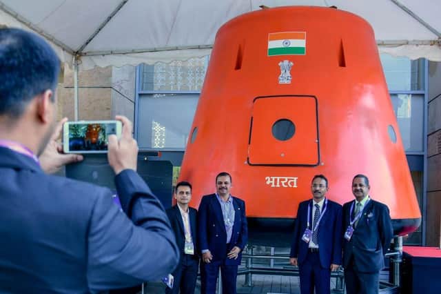 Visitors click photographs in front of a model of 'Gaganyaan' orbital module developed by Indian Space Research Organisation (ISRO) for its planned 'Man in Space' mission.