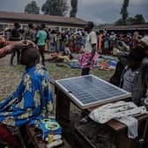 A barber, an internally displaced person who fled clashes between M23 rebels and Congolese soldiers, gives a haircut to another refugee in Kanyarushinya north of Goma in DRC.