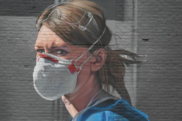 A mural of a NHS worker on a wall in north Manchester