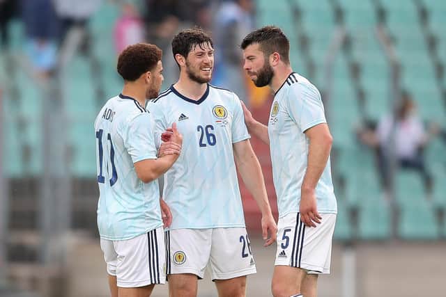 Che Adams, Scott McKenna and Grant Hanley congratulate each other after Scotland's 1-0 victory in Luxembourg. (Photo by Christian Kaspar-Bartke/Getty Images)
