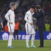 England manager Gareth Southgate consoles Jadon Sancho after defeat in the penalty shootout that decided the Euro 2020 final (Picture: Laurence Griffiths/pool via AP)