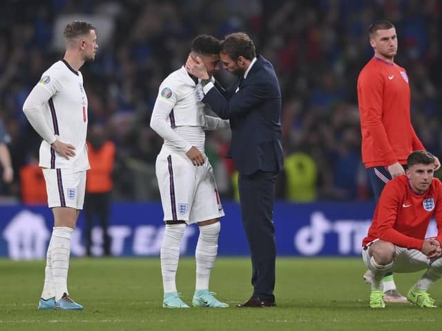 England manager Gareth Southgate consoles Jadon Sancho after defeat in the penalty shootout that decided the Euro 2020 final (Picture: Laurence Griffiths/pool via AP)