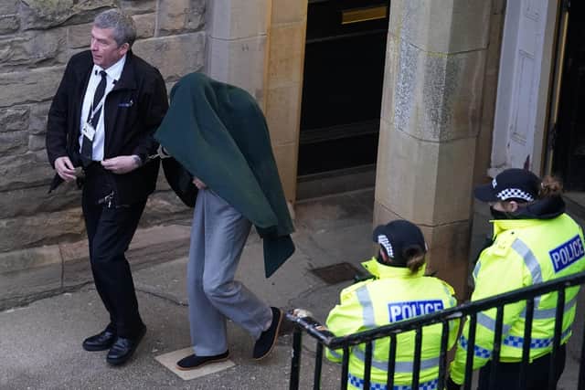 Andrew Miller, covered, is led from Selkirk Sheriff Court following an earlier hearing. The 53 year-old has admitted abducting a primary school aged girl while dressed as a woman before repeatedly sexually assaulting her. Picture: Andrew Milligan/PA Wire
