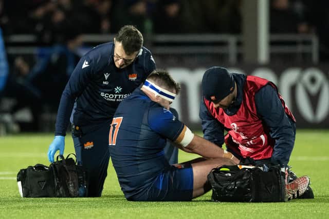 Edinburgh prop Robin Hislop receives treatment after his injury against Gloucester.