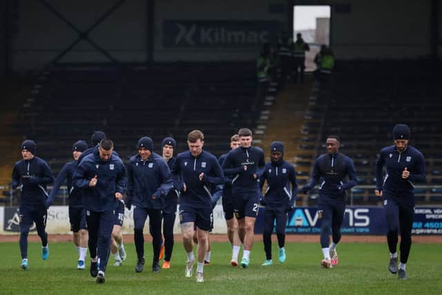 Dundee players train on the pitch after the game against Aberdeen was postponed. (Photo by Ross MacDonald / SNS Group)