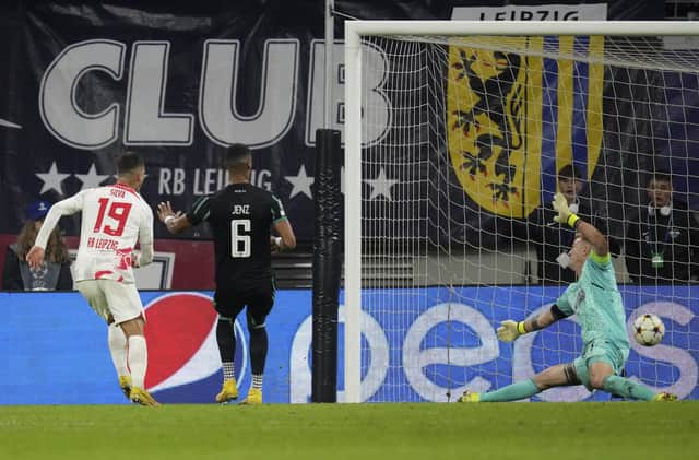 Leipzig's Andre Silva, left, scores his side's third goal against Celtic.