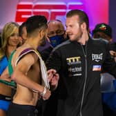 Ben Davison, centre, trainer for Josh Taylor keeps him apart from Jose Ramirez as the two face off following the weigh-in in Las Vegas. Picture: Chase Stevens/AP