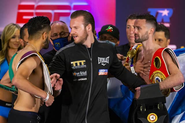 Ben Davison, centre, trainer for Josh Taylor keeps him apart from Jose Ramirez as the two face off following the weigh-in in Las Vegas. Picture: Chase Stevens/AP