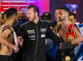 Ben Davison, centre, trainer for Josh Taylor keeps him apart from Jose Ramirez as the two face off following the weigh-in in Las Vegas. Picture: Chase Stevens/AP