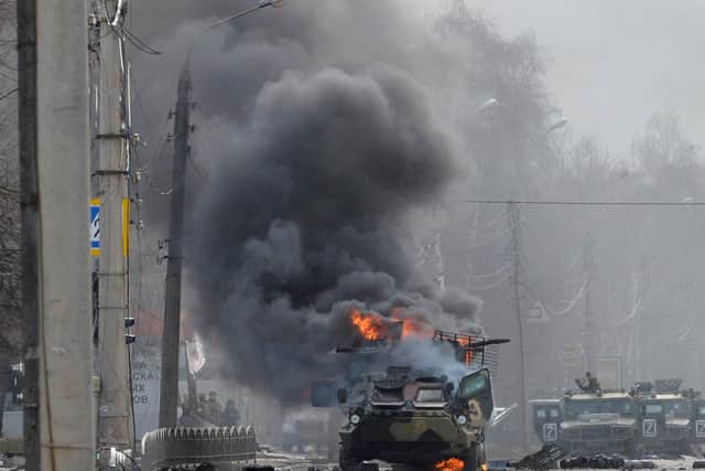 A Russian armoured personnel carrier (APC) burns in a street in Kharkiv (Picture: Sergey Bobok/AFP via Getty Images)