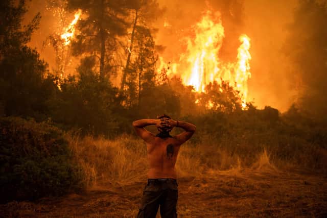 Extreme weather, like this wildfire in Greece, is one of the consequences of global warming (Picture: Angelos Tzortzinis/AFP via Getty Images)
