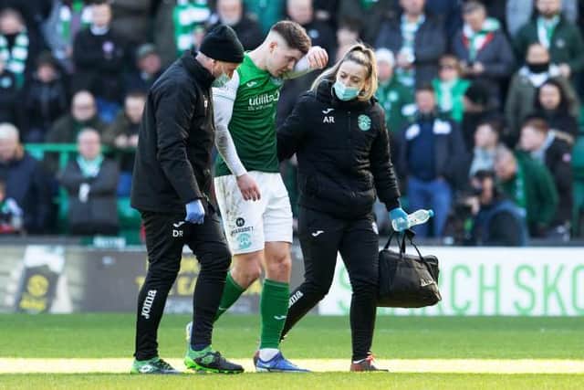 Kevin Nisbet goes off injured during a Cinch Premiership match between Hibernian and Celtic. (Photo by Ross Parker / SNS Group)