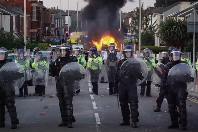 Riot police hold back protesters after disorder broke out in Southport, England. Picture: Getty Images