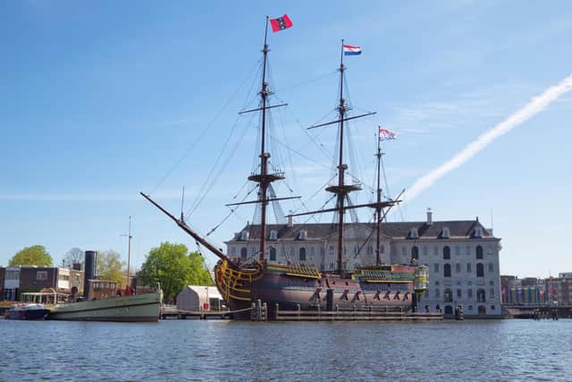 A replica of a historic three-masted clipper moored in front of the National Maritime Museum in Amsterdam. Pic: Alamy/PA.