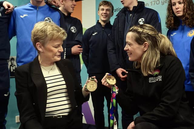 Yvonne Murray-Mooney, the 1993 World Athletics Indoor champion, shows off one of her medals alongside fellow athlete Eilidh Doyle. Picture: John Devlin