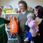 Foodbank volunteer Lizzie Abnett hands over a donation of food. Picture: Matt Cardy/Getty Images