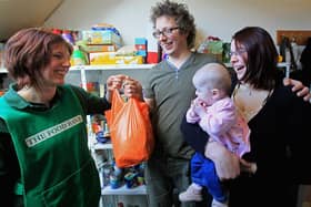 Foodbank volunteer Lizzie Abnett hands over a donation of food. Picture: Matt Cardy/Getty Images