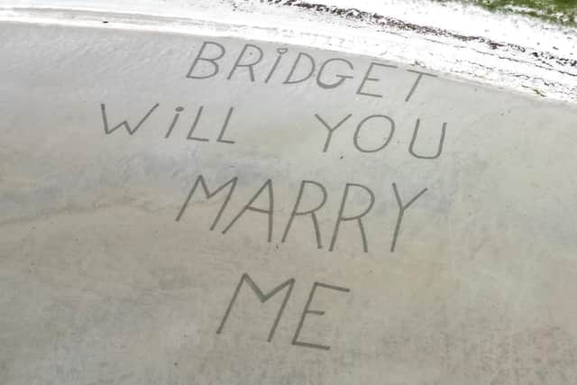 The marriage proposal written in the sand at Barra beach.