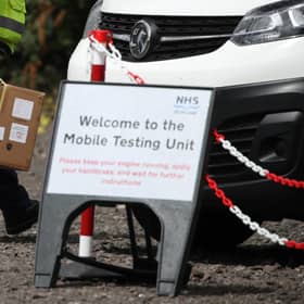Staff from the Scottish Ambulance Service carry boxes of test kits from a van at a Covid Mobile Testing Unit. Picture: PA Media